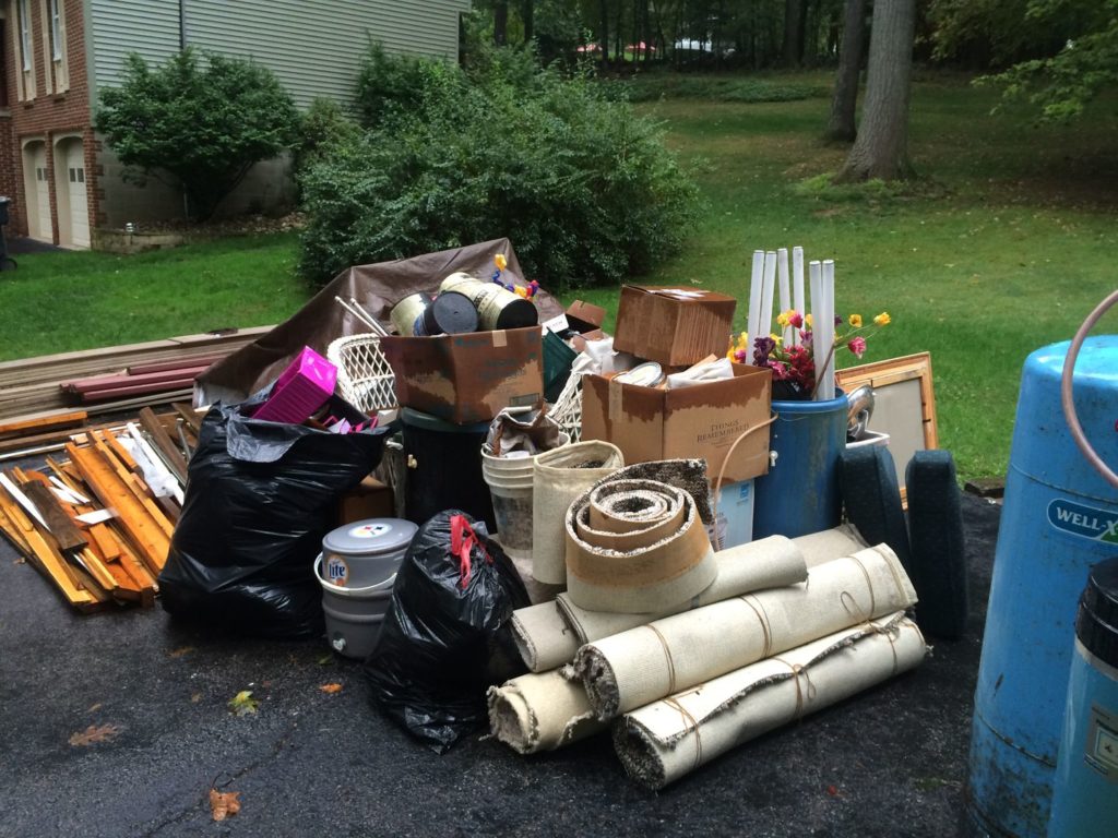 AJ's Junk Removal LLC team actively working at a residential property in Brookfield, CT